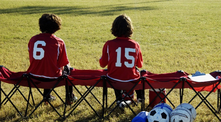 Youth soccer news - Advice for soccer tryouts - youth soccer players sitting on soccer bench