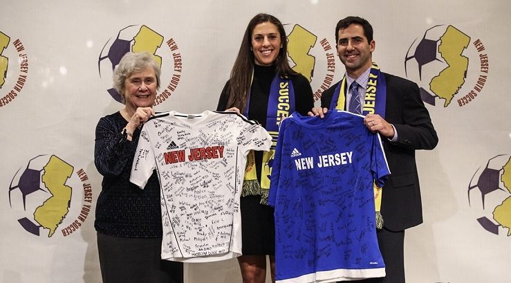 NJYS President Evelyn Gill and NJYS Executive Director Evan Dabby present Carli Lloyd with jerseys signed by the NJYS players in attendance (Photo by Jeffrey Auger)